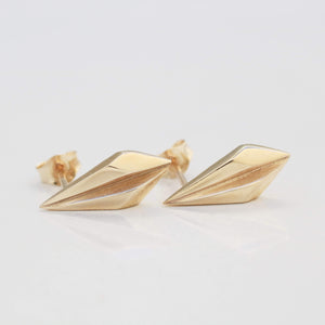 Pair of gold geometric earrings photographed on pale grey, thoughtful bridesmaid gift idea.