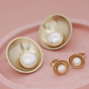 Large and small versions of handmade 9ct gold pearl earrings shown side by side