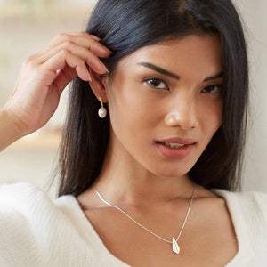 Close-up of 9ct gold pearl earrings worn with bridal dress – 9ct gold pearl earrings for modern bride