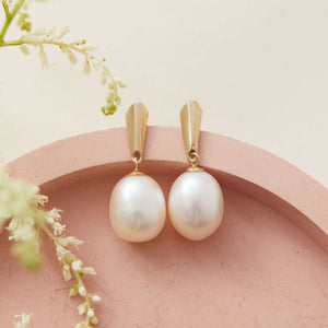 9ct gold pearl earrings on pink dish showcasing elegant drop design – gold bridal earrings for wedding style inspiration