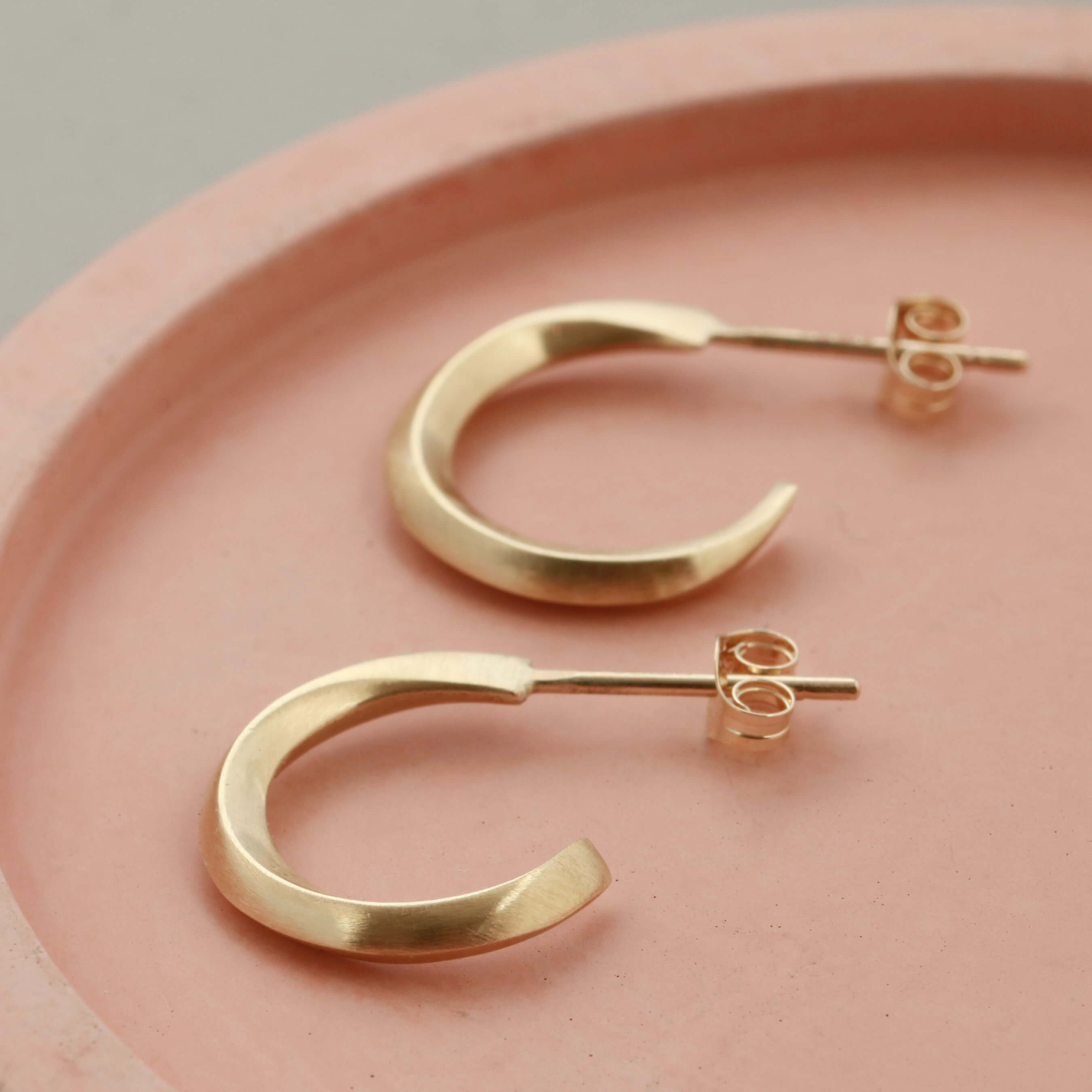 Real gold small hoop earrings on a pale pink dish, 9ct hoop earrings birthday gift idea