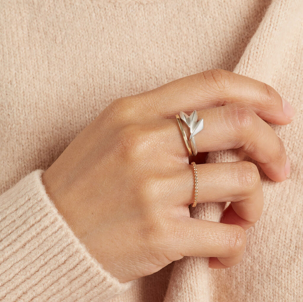 Sterling silver statement ring worn on a woman's hand, featuring a bold Art Deco-inspired geometric fan shape