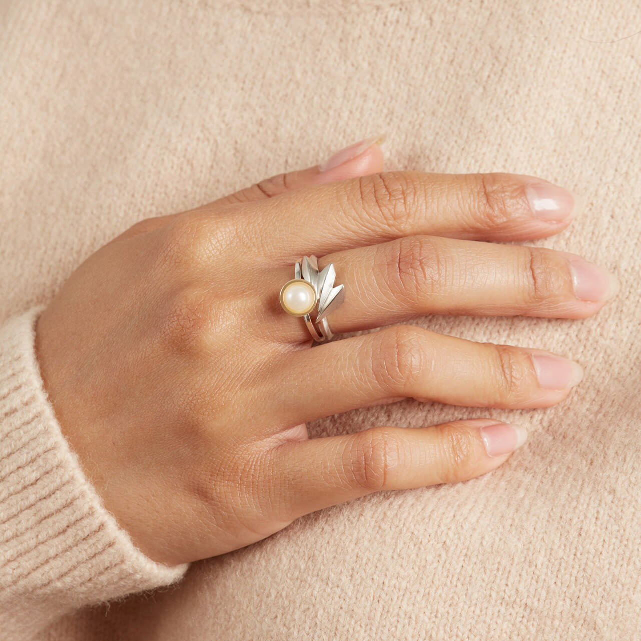 Art Deco style ring in solid sterling silver modelled on a woman's hand, showing the fan-shaped design and polished finish