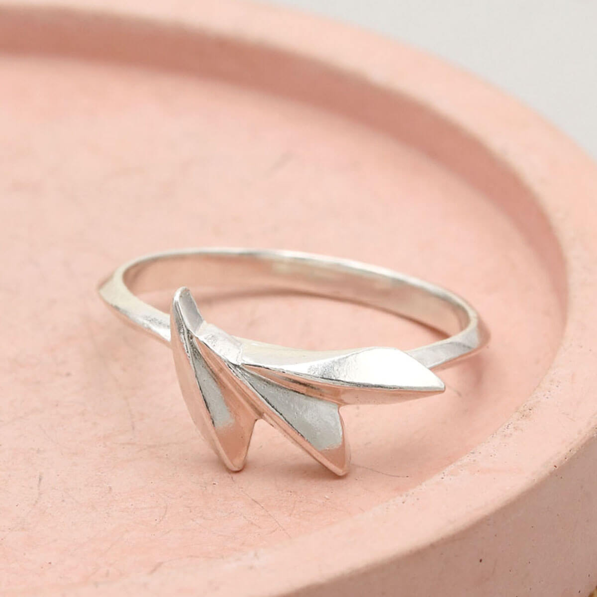 Handmade Art Deco silver ring in solid sterling silver, featuring a sculptural concertina fan shape on a pink dish