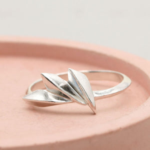 Sterling silver fan ring with concertina geometric design, handmade Art Deco silver ring photographed on a pink dish