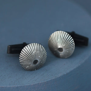 Silver and black cufflinks shown face-on against deep blue backdrop, elegant mens luxury cufflinks for Father’s Day or wedding.