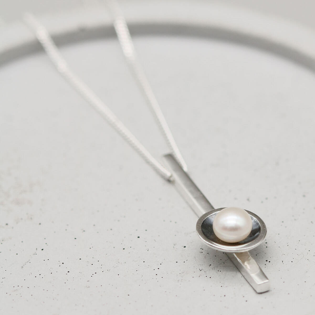 Black pearl bar necklace featuring a freshwater pearl in an oxidised sterling silver Art Deco inspired pendant.