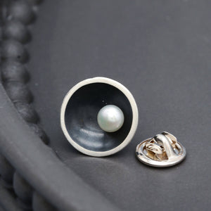 Handmade black pearl tie pin displayed on a dark grey background, showcasing the elegant Art Deco inspired design.
