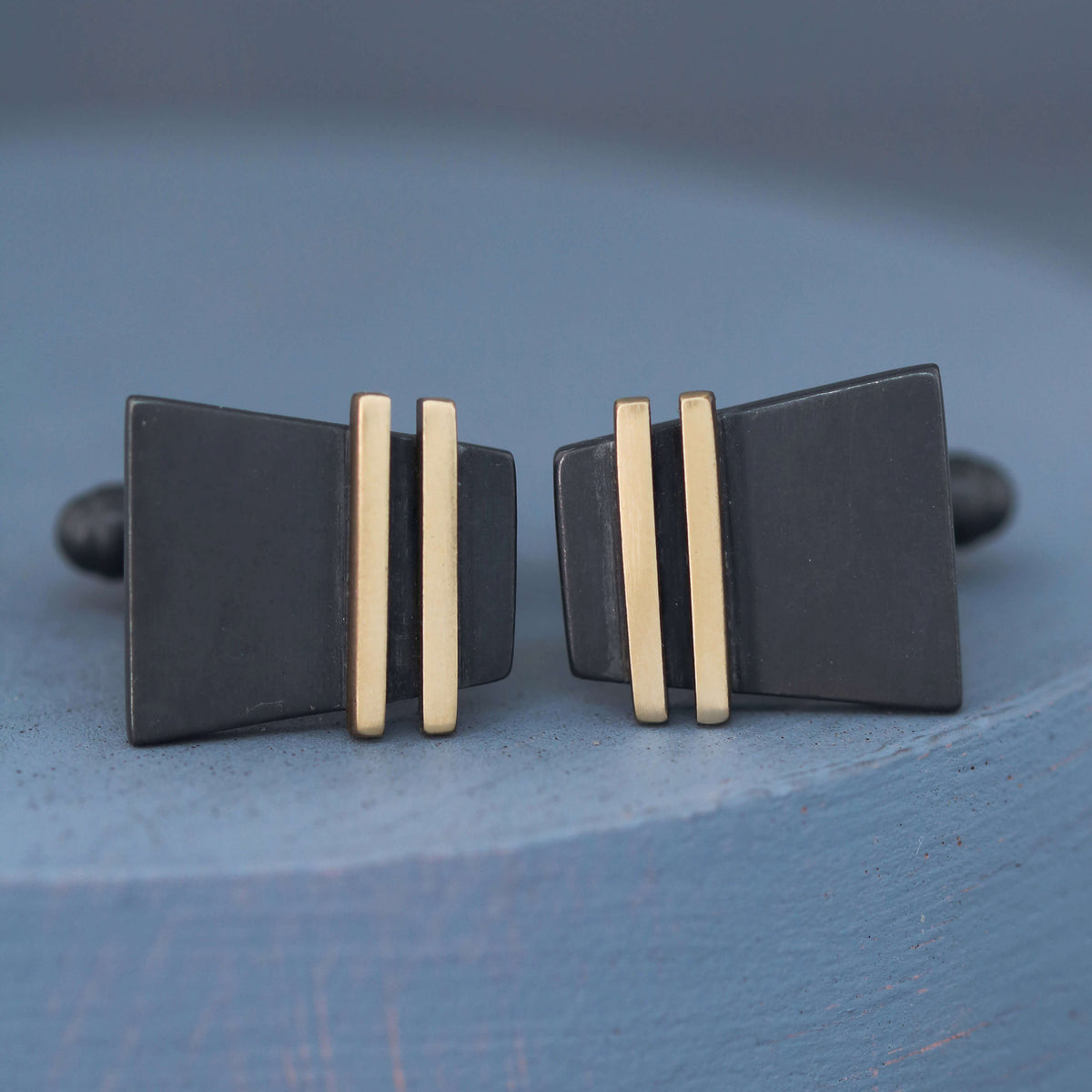 Black and Gold cufflinks on a deep blue background showing modern pinstripe design, perfect special cufflinks gift for him for weddings or anniversaries.