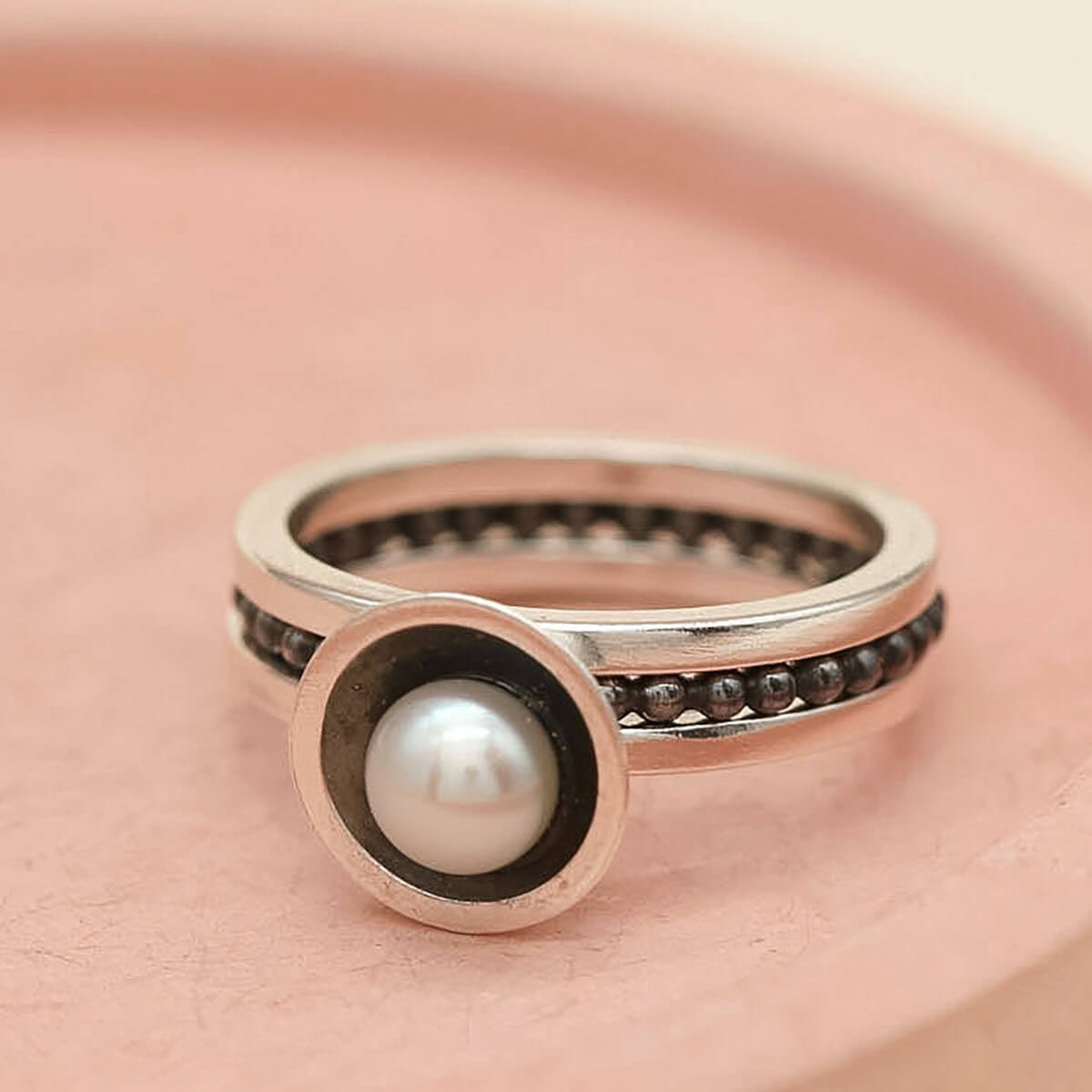 Handmade stacking ring set featuring a black pearl ring and sterling silver bands