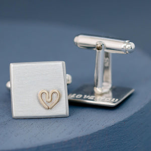 Single cufflink shown from the side to highlight the sturdy silver fitting and contrast of gold detail — Custom cufflinks for groom.
