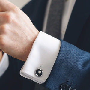 Handmade sterling silver pearl cufflinks styled on a white shirt cuff, highlighting the double-sided chain design.