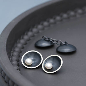 Detailed view of double-sided pearl cufflinks highlighting the contrast between oxidised silver and lustrous pearls.