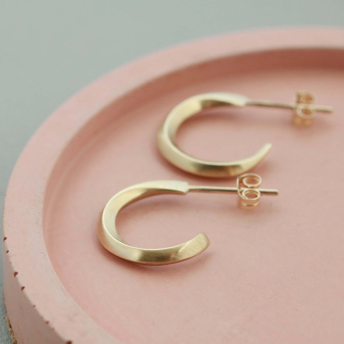 9ct hoop earrings displayed on a pale pink dish, real gold small hoop earrings gift for her
