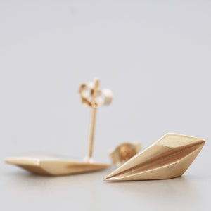 Gold art deco earrings displayed on a pale grey background, handmade 9ct gold geometric gift for her.