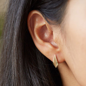 Model wearing gold art deco earrings, elegant gold geometric earrings for bridal jewellery.