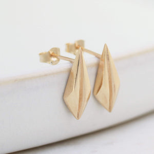 Gold art deco earrings angled on pale grey, perfect gold geometric earrings for weddings.