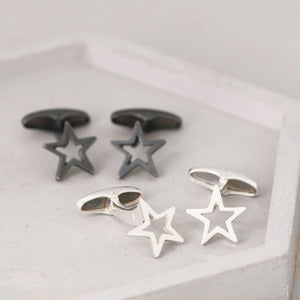 Silver and black Star cufflinks side by side on a grey ceramic dish – a modern and meaningful graduation gift for son or special occasion.