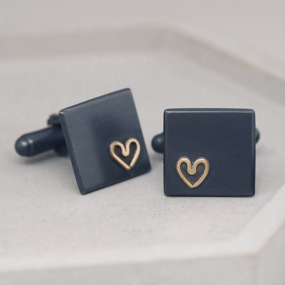 Close-up showing brushed matte texture and gold heart motif, timeless Groom wedding cufflinks for romantic occasions.