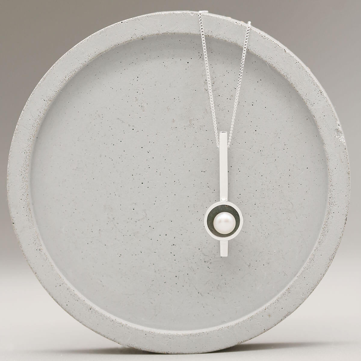 Close up of a simple pearl necklace handcrafted in oxidised sterling silver with a genuine freshwater pearl.