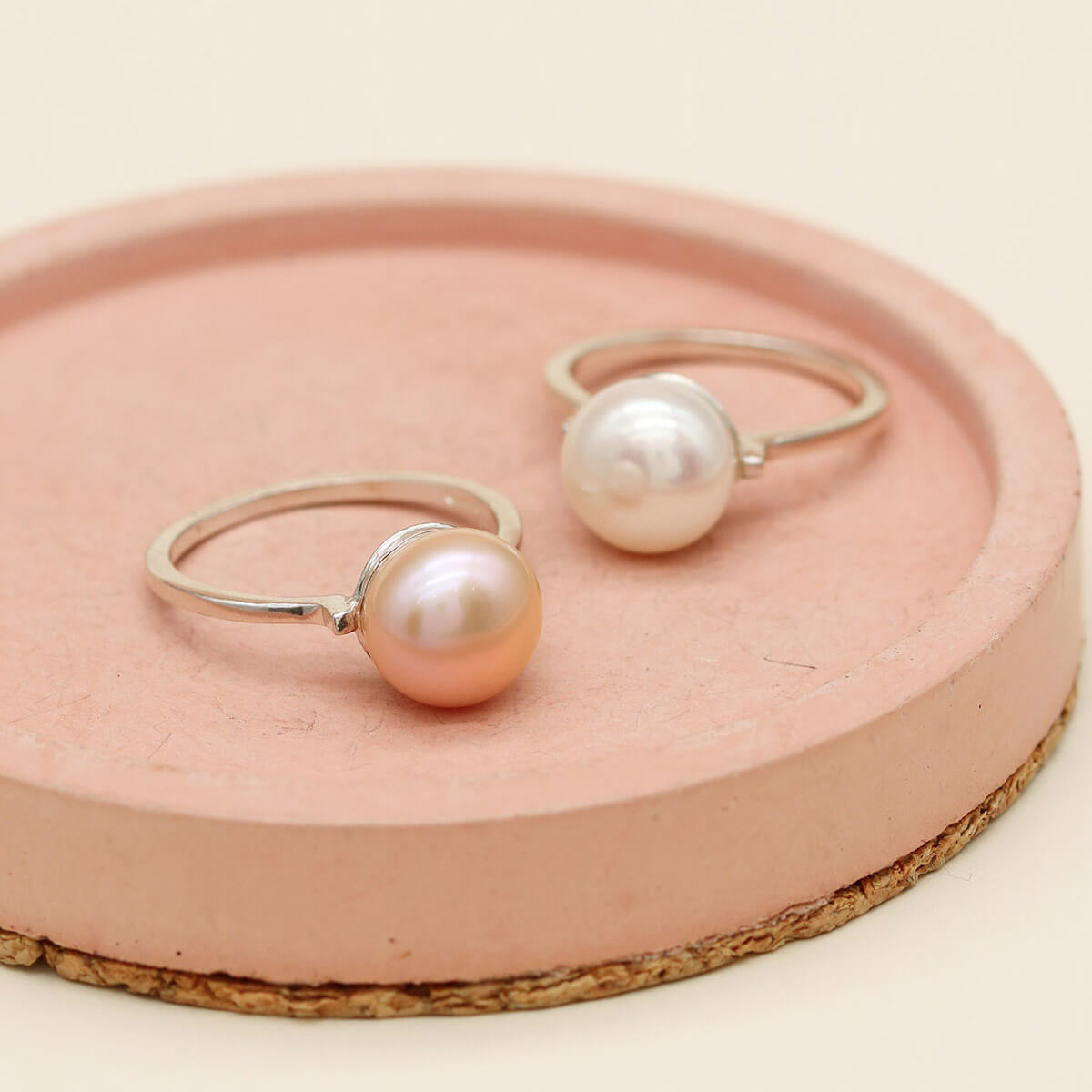 Peach pink and ivory white freshwater pearl rings displayed together