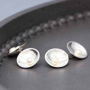 Double-sided pearl cufflinks in sterling silver featuring genuine freshwater pearls and Art Deco inspired styling.