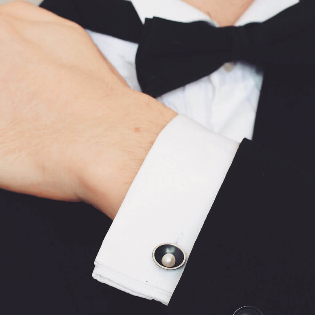 Men's black pearl cufflinks styled with formal wedding attire, featuring genuine freshwater pearls.