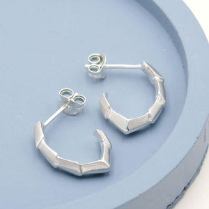 Handmade silver earrings with a geometric half hoop design, an unusual alternative to traditional silver hoops