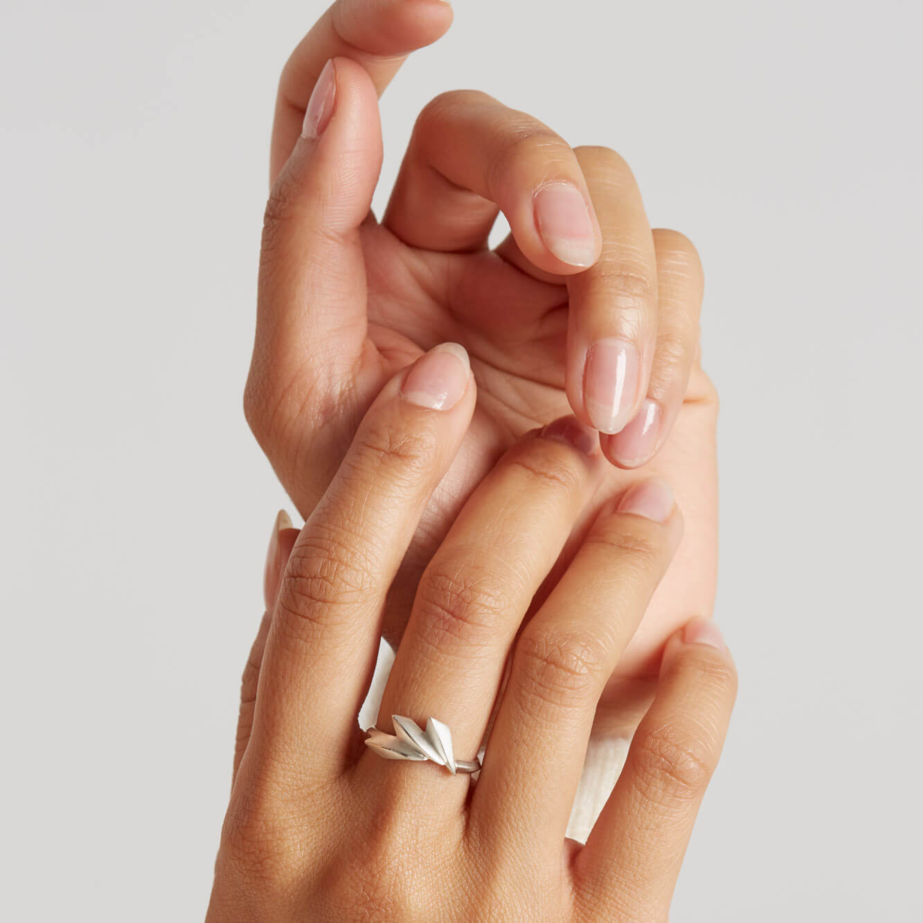 Woman wearing a geometric Art Deco ring in sterling silver, showing the 15mm fan detail and sculptural design