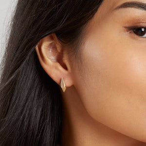 Gold geometric earrings worn with bridal outfit, chic art deco wedding jewellery.