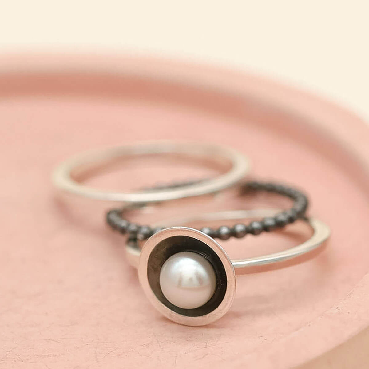 Sterling silver stacking rings featuring a freshwater pearl and oxidised silver finish