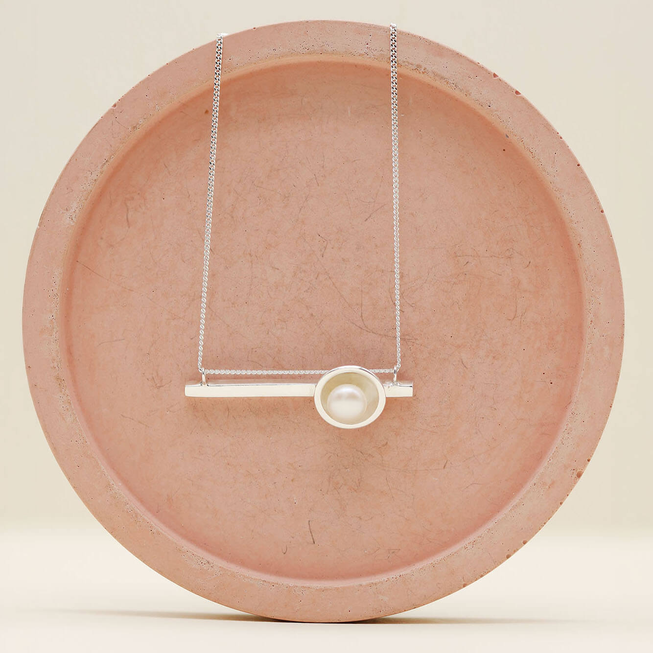 Contemporary pearl necklace crafted in solid sterling silver featuring a polished horizontal bar and freshwater pearl.