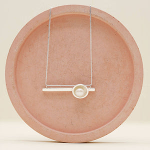 Contemporary pearl necklace crafted in solid sterling silver featuring a polished horizontal bar and freshwater pearl.