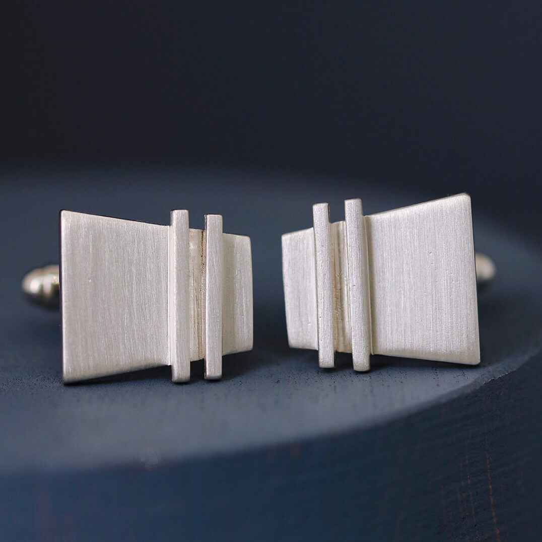 Single Modern cufflink close-up focusing on the subtle pinstripe pattern and refined silver surface, perfect nice anniversary gift for husband