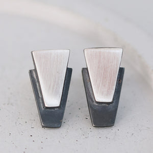 Contemporary black stud earrings for women displayed on grey dish, sterling silver finish ideal for everyday or wedding day gifts.