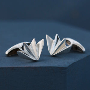 Close-up of men’s silver cufflinks on deep blue background showing detailed art deco fan pattern, perfect gift for husband or wedding day accessory