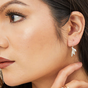 Art deco drop earrings styled on model with hair tucked back, emphasising the geometric fan shape; great gift for her birthday or anniversary.