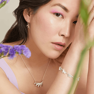 Model shot wearing sterling silver art deco drop earrings for an everyday yet sophisticated look; thoughtful Christmas jewellery gift.