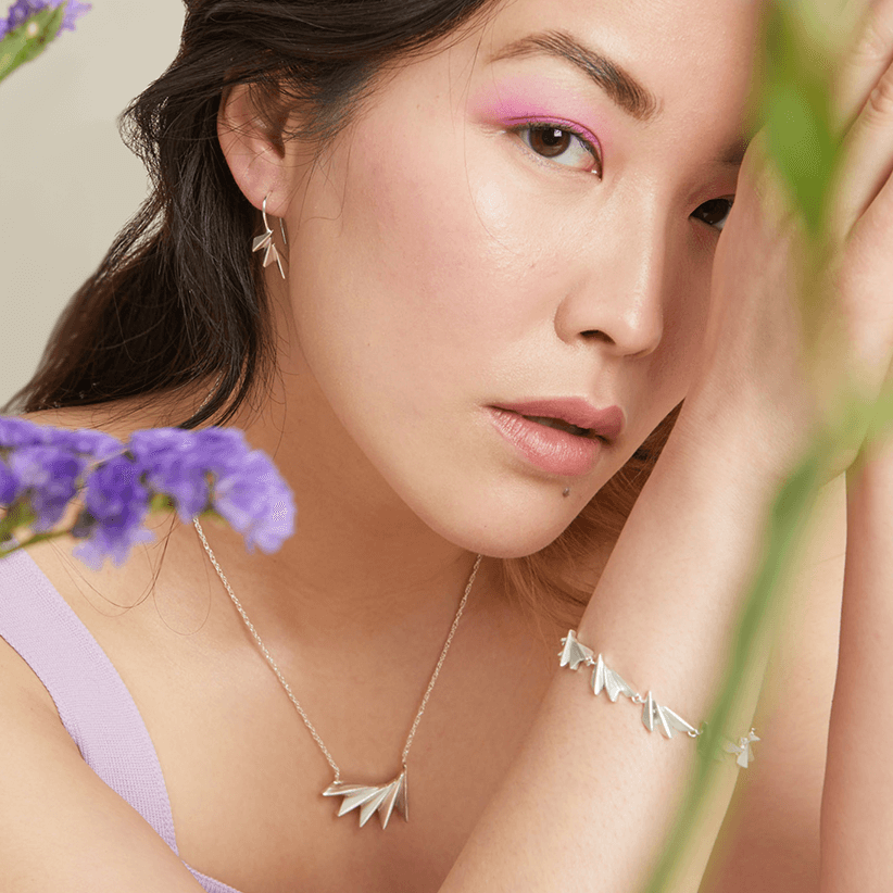 Model shot wearing sterling silver art deco drop earrings for an everyday yet sophisticated look; thoughtful Christmas jewellery gift.