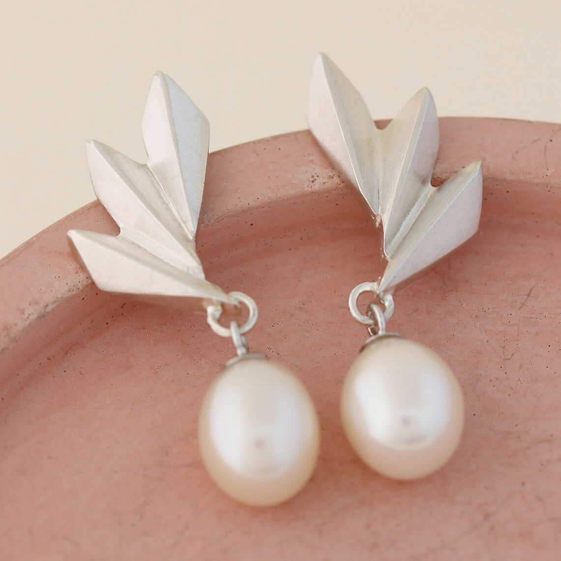 Side angle of Art Deco pearl earrings showing depth of the silver fan and dangling pearl, sophisticated present for birthdays or special occasions.