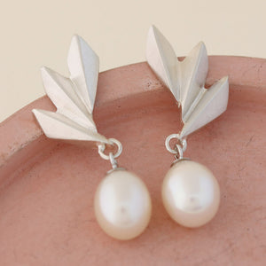 Side angle of Art Deco pearl earrings showing depth of the silver fan and dangling pearl, sophisticated present for birthdays or special occasions.