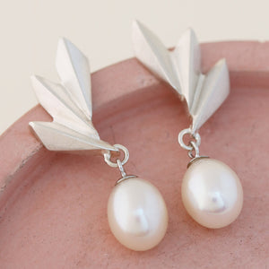 Sterling silver drop pearl earrings displayed on a neutral background, showing the Art Deco fan detail and teardrop pearl — ideal gift for brides or anniversaries.