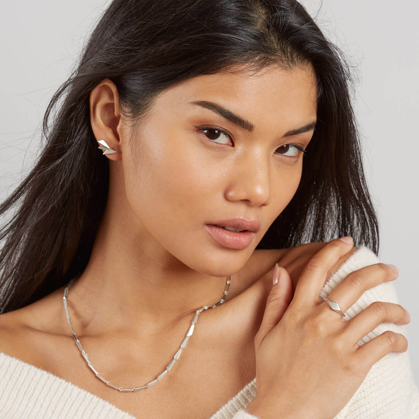 Model wearing art deco fan earrings for a clean view of their Art Deco lines.