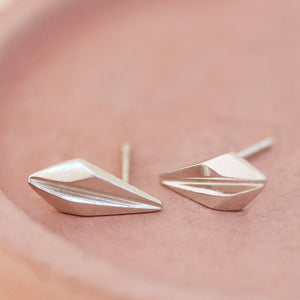 Sterling silver art deco stud earrings arranged on a pink dish, ideal for customers seeking art deco style earrings for weddings or modern jewellery lovers.