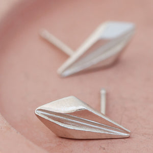 Sterling silver art deco stud earrings displayed on a pink dish, showcasing the geometric detailing of these art deco style earrings, ideal for gifting or weddings.