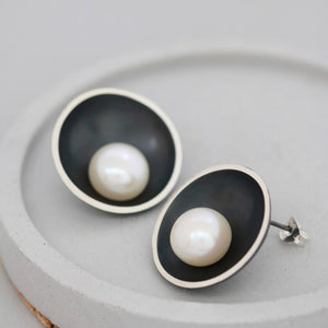 Modern pearl earrings with an oxidised silver dome and freshwater pearl