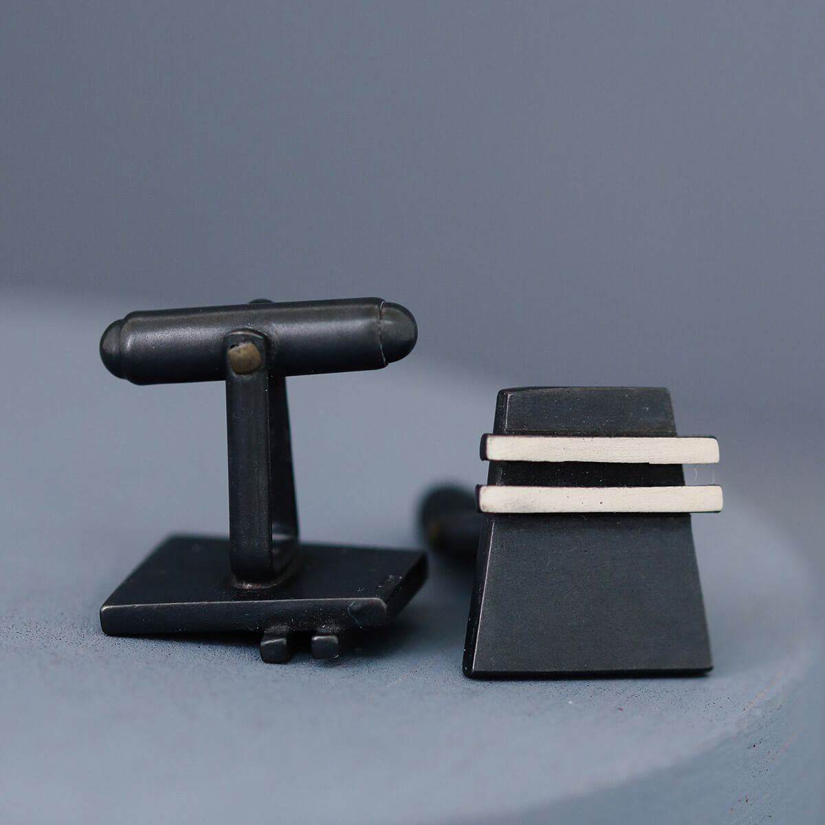 Side view of black cufflinks highlighting tapered shape and subtle shine. Great for anniversary or Father’s Day gifting.