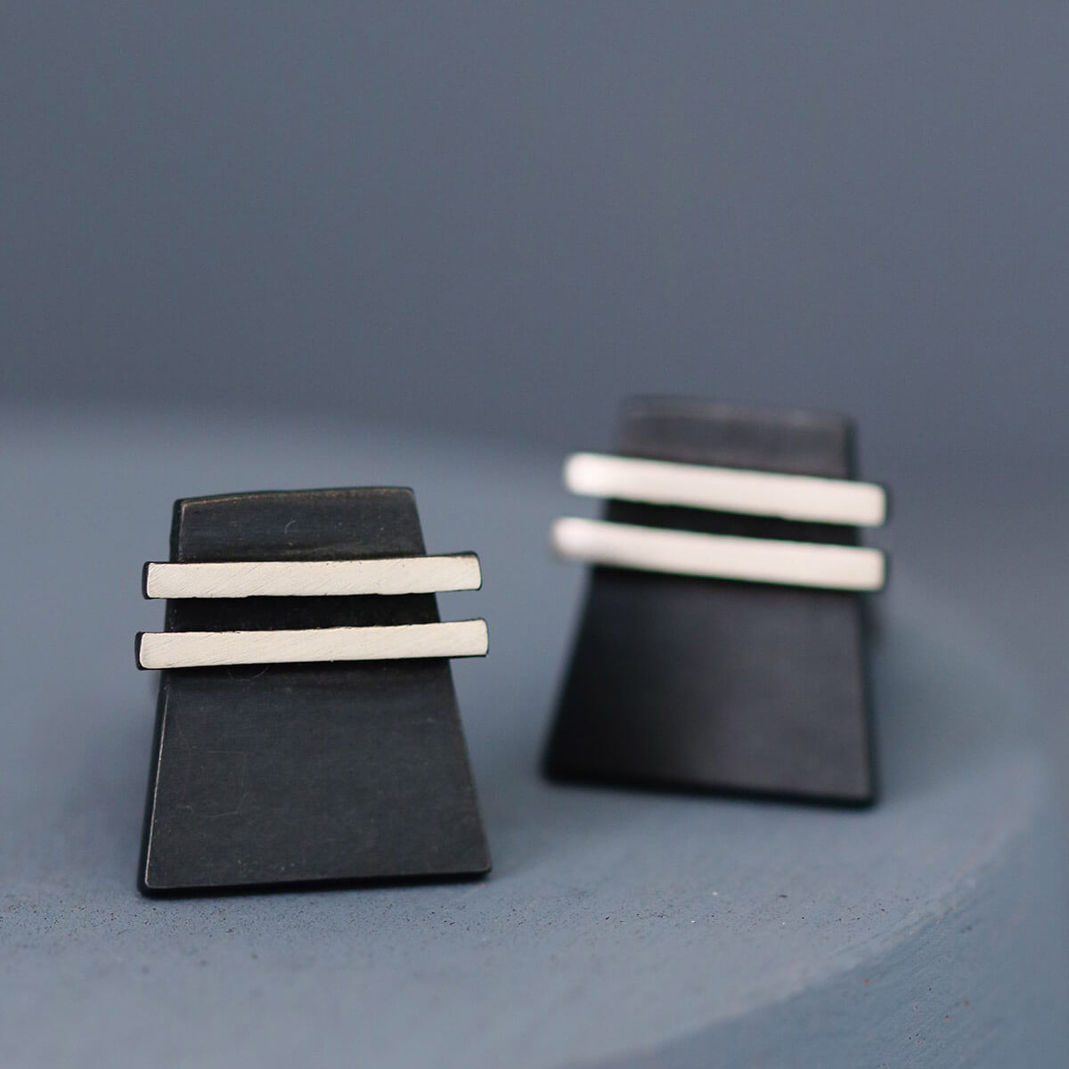 One cufflink face-on and one slightly upturned to show the cufflink fitting. Elegant and modern birthday gift idea for husband.
