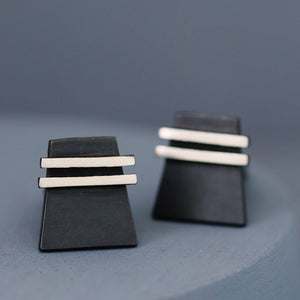One cufflink face-on and one slightly upturned to show the cufflink fitting. Elegant and modern birthday gift idea for husband.