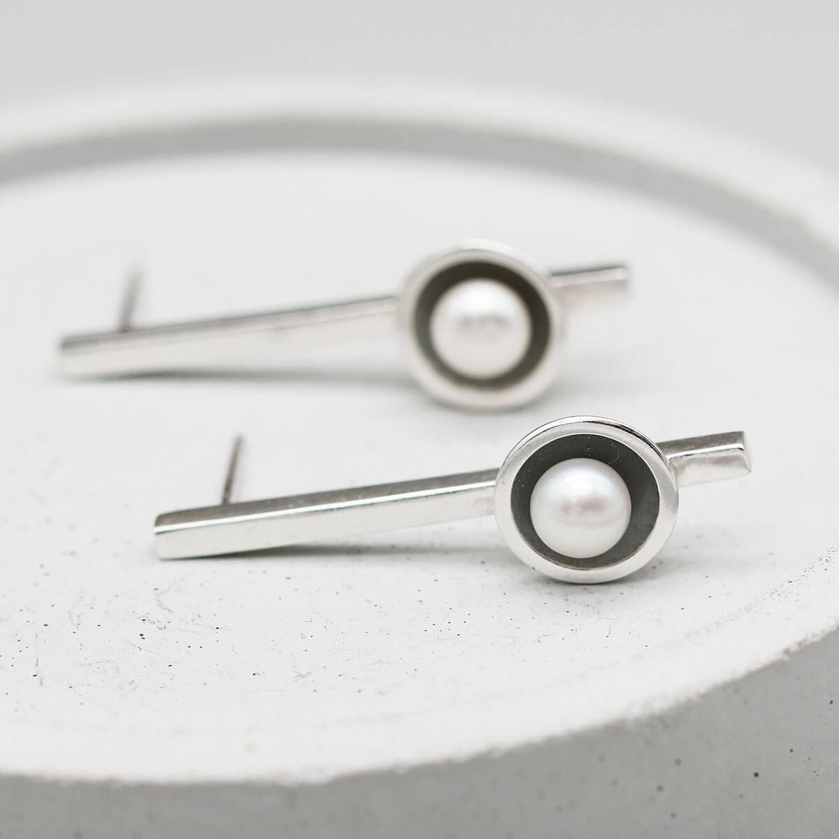 Oxidised sterling silver long pearl earrings inspired by Art Deco design with handcrafted freshwater pearl settings.